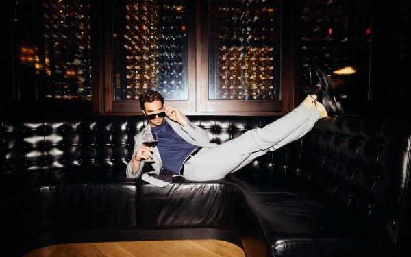 A man laying on the couch in at the SteakBar